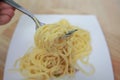 Spaghetti carbonara with cream on white plate