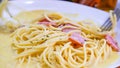 The spaghetti carbonara with fried cheese in a white plate on the table Royalty Free Stock Photo