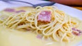 The spaghetti carbonara with fried cheese in a white plate on the table Royalty Free Stock Photo