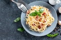 Spaghetti Carbonara on gray table. Homemade pasta with bacon, egg, hard parmesan cheese and cream sauce. Top view, copy space Royalty Free Stock Photo