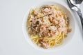 Spaghetti Carbonara sauce, cream cheese and ham is placed on the table. Royalty Free Stock Photo