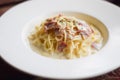 Spaghetti Carbonara in white dish on wood table Royalty Free Stock Photo