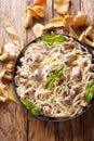 Spaghetti with chanterelle mushrooms in cream sauce with basil close-up on a plate. Vertical top view Royalty Free Stock Photo