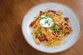 Spaghetti with crispy bacon and garlic and chilli topped with po Royalty Free Stock Photo