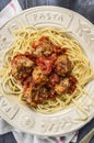 Spaghetti with delicious meatballs made from ground beef in a spicy tomato sauce in a plate with inscription pasta on wooden Royalty Free Stock Photo