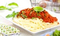 Spaghetti dinner with meat sauce and basil close up Bolognese. Royalty Free Stock Photo