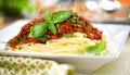 Spaghetti dinner with meat sauce and basil close up Bolognese. Royalty Free Stock Photo