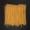 Spaghetti from durum wheat on black background. Italian raw pasta Royalty Free Stock Photo