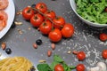 Spaghetti and fettuccine with ingredients for cooking pasta on wooden table with blank of round wooden kitchen board Royalty Free Stock Photo