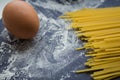 Spaghetti and flour and egg on black background Royalty Free Stock Photo