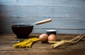 Spaghetti and flour and eggs with kitchenware on wooden background Royalty Free Stock Photo