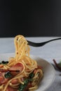 Spaghetti on a fork. Spaghetti Bacon chili garlic basil in white plate. Popular menu classic italian cuisine dish. Royalty Free Stock Photo