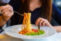 Spaghetti on a fork. Girl use fork with spaghetti. Pasta with red sauce Royalty Free Stock Photo