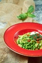 Spaghetti with fresh green peas. Gray textured background with beige fabric. Beautiful serving of dishes. Restaurant Royalty Free Stock Photo