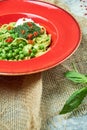 Spaghetti with fresh green peas. Gray textured background with beige fabric. Beautiful serving of dishes. Restaurant Royalty Free Stock Photo