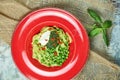 Spaghetti with fresh green peas. Gray textured background with beige fabric. Beautiful serving of dishes. Restaurant Royalty Free Stock Photo