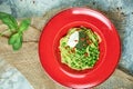 Spaghetti with fresh green peas. Gray textured background with beige fabric. Beautiful serving of dishes. Restaurant Royalty Free Stock Photo