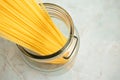 Spaghetti in glass jar and copy space. Ingredient for Italian pasta. Raw food and cookware Royalty Free Stock Photo