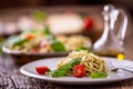 Spaghetti. Italian pasta spaghetti with basil pesto cherry tomatoes and olive oil Royalty Free Stock Photo