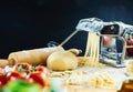 Spaghetti machine cutting dough into noodles