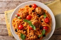 Spaghetti with meat balls, vegetables in a tomato sauce close-up on a plate on a table. horizontal top view, rustic Royalty Free Stock Photo