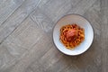 Spaghetti and meatballs in a bowl on a table