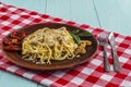 Spaghetti with mushrooms in cream sauce on a blue wooden background. Royalty Free Stock Photo