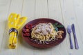 Spaghetti with mushrooms in cream sauce on a yellow wooden background. Royalty Free Stock Photo