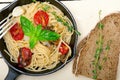 Spaghetti pasta with baked cherry tomatoes and basil Royalty Free Stock Photo