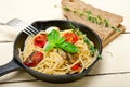 Spaghetti pasta with baked cherry tomatoes and basil Royalty Free Stock Photo