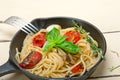 Spaghetti pasta with baked cherry tomatoes and basil Royalty Free Stock Photo