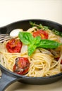 Spaghetti pasta with baked cherry tomatoes and basil Royalty Free Stock Photo