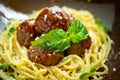 Spaghetti pasta and meat balls in tomato sauce in brown plate with Basil and Parmesan on wooden background Royalty Free Stock Photo