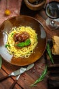 Spaghetti pasta and meat balls in tomato sauce in brown plate with Basil and Parmesan on wooden background Royalty Free Stock Photo