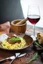 Spaghetti pasta and meat balls in tomato sauce in brown plate with Basil and Parmesan on wooden Royalty Free Stock Photo