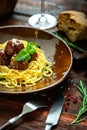Spaghetti pasta and meat balls in tomato sauce in brown plate with Basil and Parmesan Royalty Free Stock Photo