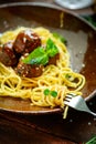 Spaghetti pasta and meat balls in tomato sauce in brown plate with Basil and Parmesan Royalty Free Stock Photo