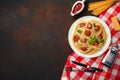 Spaghetti pasta with meatballs, cherry tomato sauce on rusty background