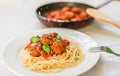 Spaghetti pasta with meatballs in tomato sauce, cheese falling over it Royalty Free Stock Photo