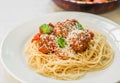 Spaghetti pasta with meatballs in tomato sauce, cheese falling over it Royalty Free Stock Photo