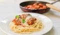 Spaghetti pasta with meatballs in tomato sauce, cheese falling over it Royalty Free Stock Photo