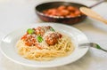 Spaghetti pasta with meatballs in tomato sauce, cheese falling over it Royalty Free Stock Photo
