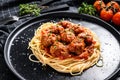 Spaghetti pasta with meatballs and tomato sauce. Italian cuisine. Black background. Top view Royalty Free Stock Photo