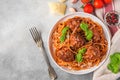 Spaghetti pasta with meatballs, tomato sauce, parmesan cheese and basil in a plate with fork. italian food. top view Royalty Free Stock Photo