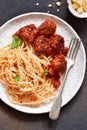 Spaghetti pasta with meatballs, tomato sauce and parmesan on the kitchen table. View from above Royalty Free Stock Photo