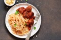 Spaghetti pasta with meatballs, tomato sauce and parmesan on the kitchen table. View from above Royalty Free Stock Photo