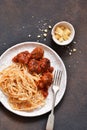Spaghetti pasta with meatballs, tomato sauce and parmesan on the kitchen table. View from above Royalty Free Stock Photo