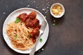 Spaghetti pasta with meatballs, tomato sauce and parmesan on the kitchen table. View from above Royalty Free Stock Photo