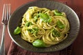 Spaghetti pasta with pesto sauce over rustic table Royalty Free Stock Photo