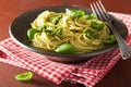 Spaghetti pasta with pesto sauce over rustic table Royalty Free Stock Photo